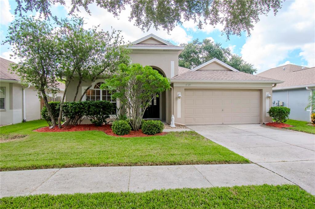 a front view of a house with a yard and garage