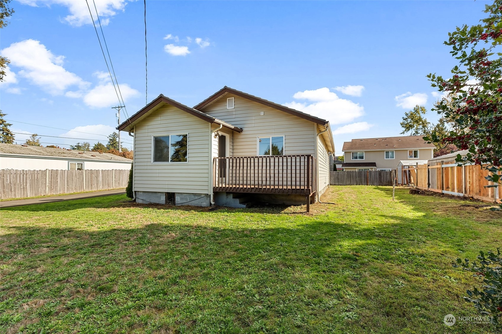 a view of a house with a yard and deck