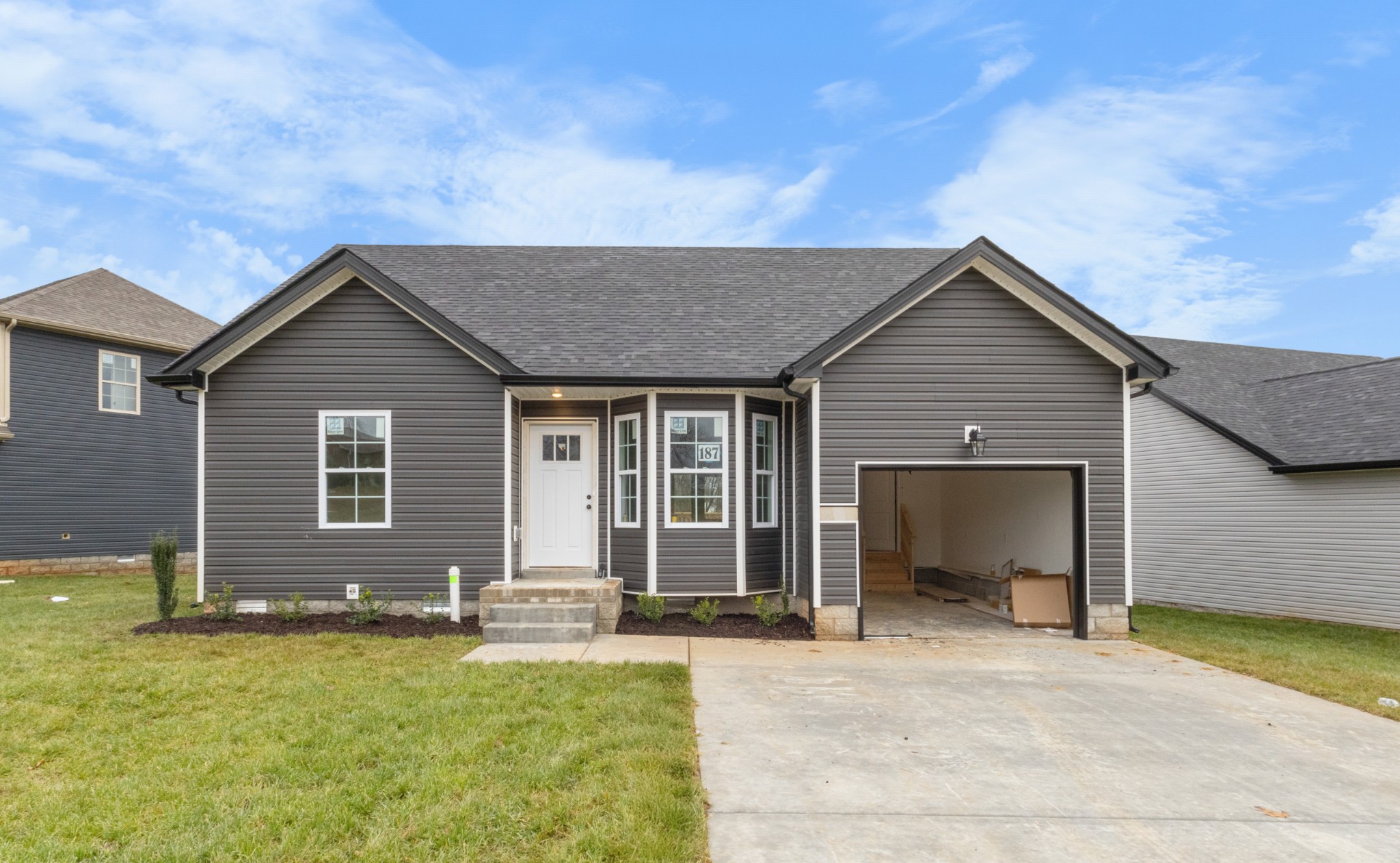 a front view of a house with a yard and garage