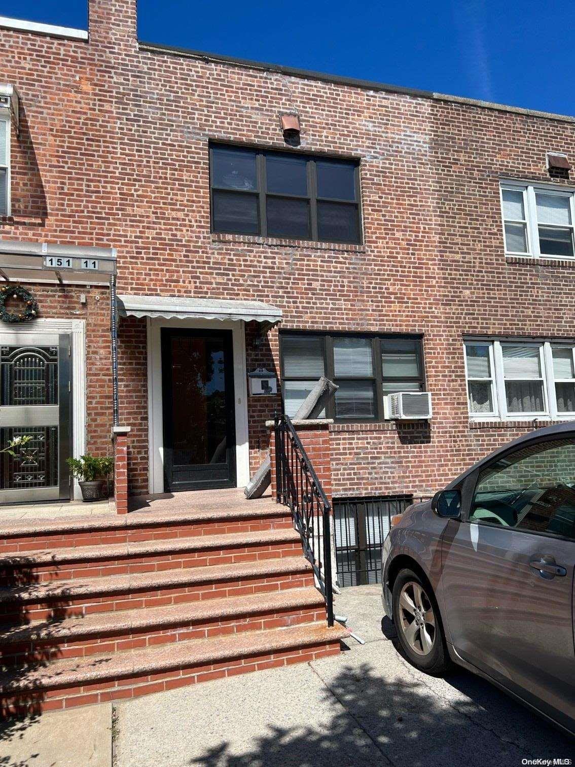 a front view of a house with a parking space