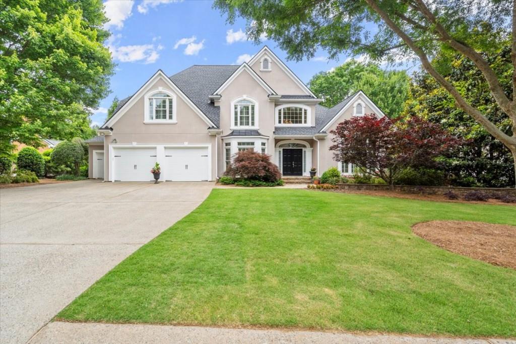 a front view of house with yard and green space