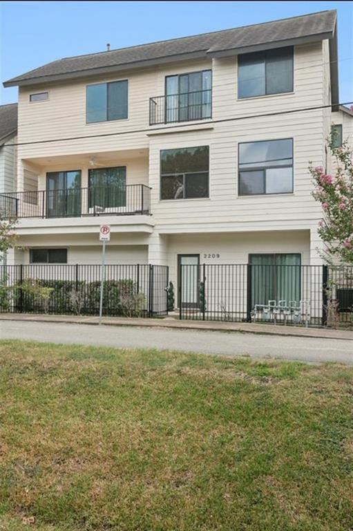 a front view of residential houses with yard