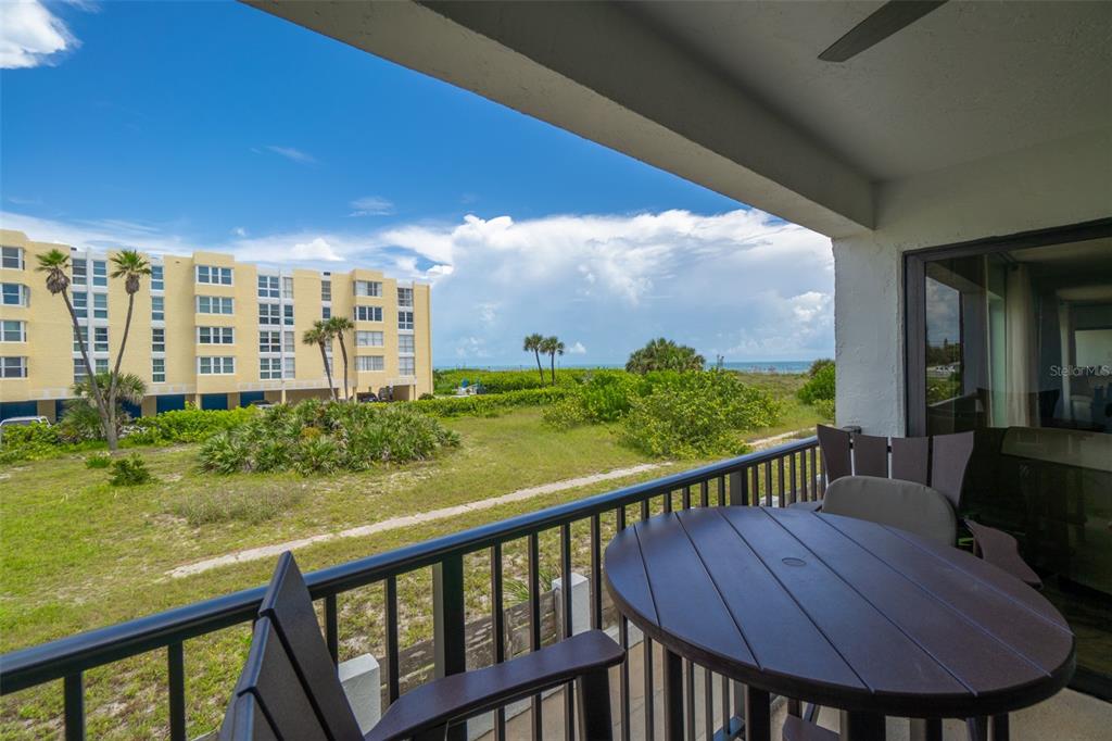 a view of a balcony with lake view and wooden floor