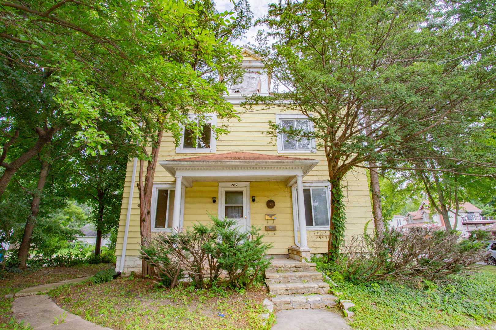 a front view of a house with garden