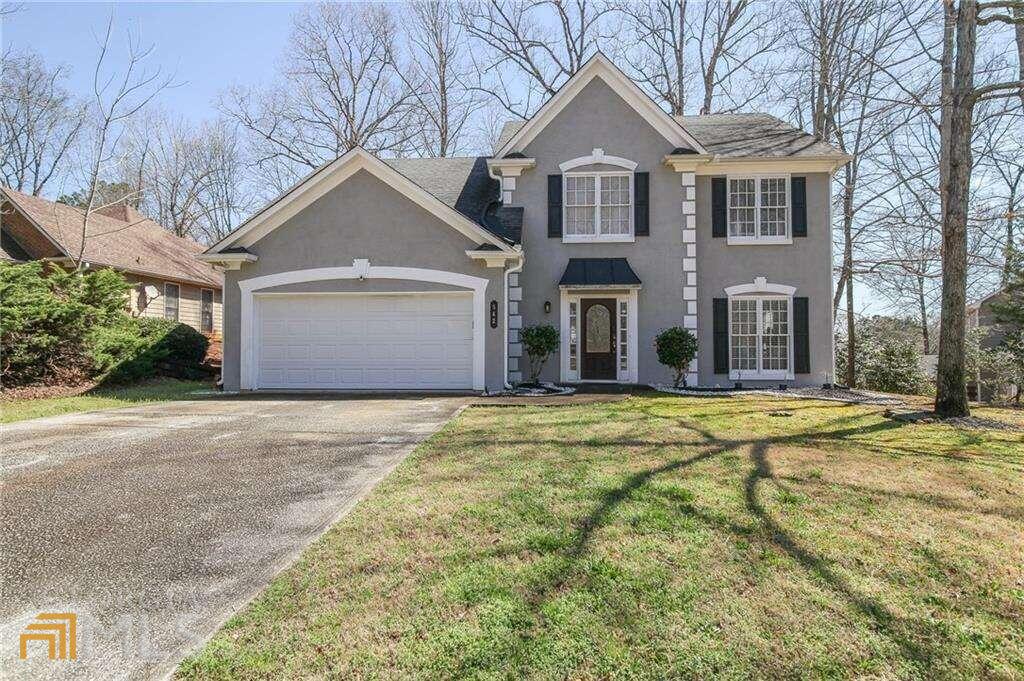 a front view of a house with a yard and garage