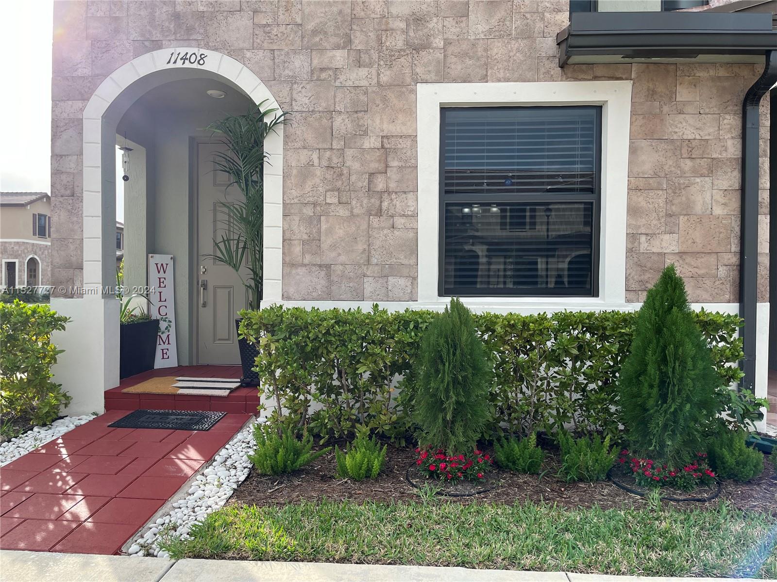 a front view of a house with garden