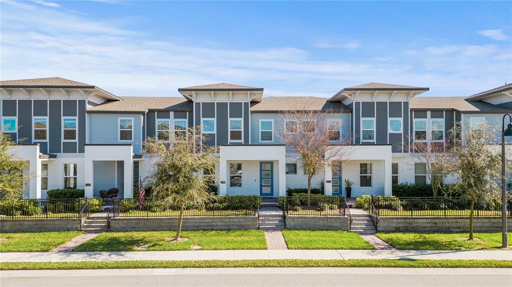 a front view of a residential apartment building with a yard