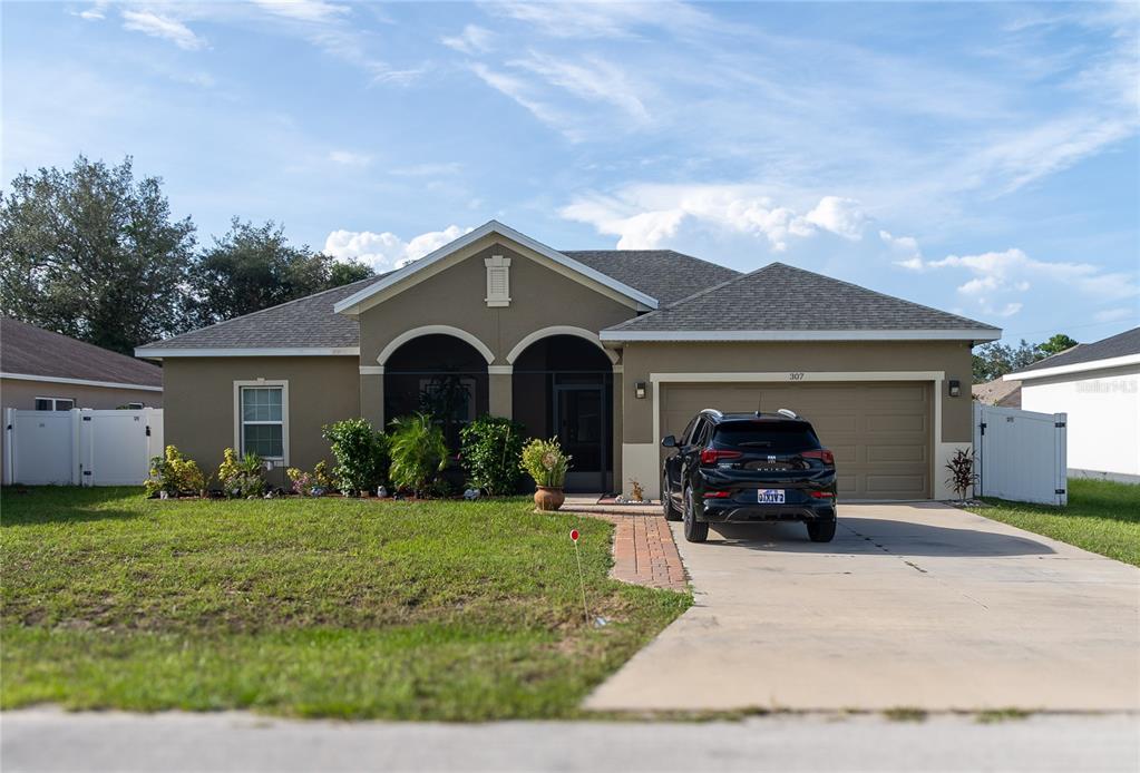 a front view of a house with garden