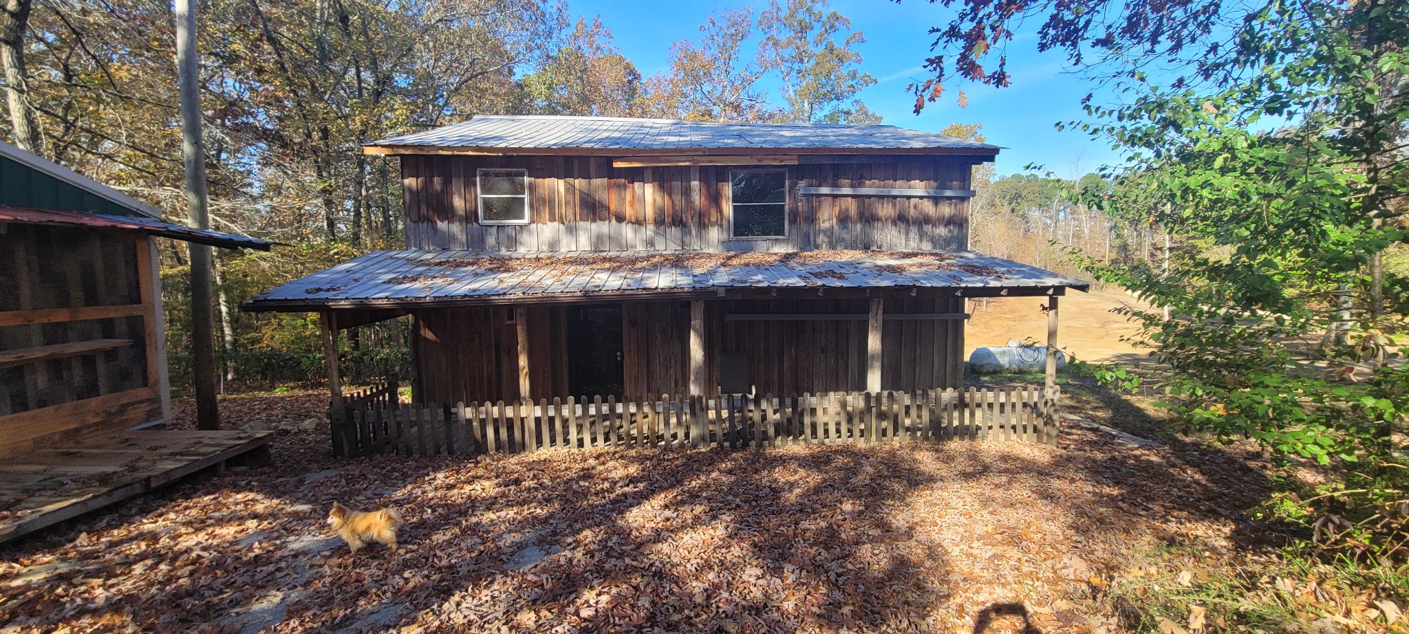 a front view of house with yard outdoor seating and barbeque oven