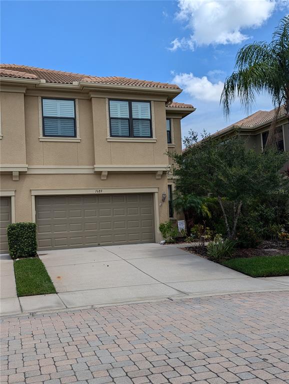 a front view of a house with a yard and garage