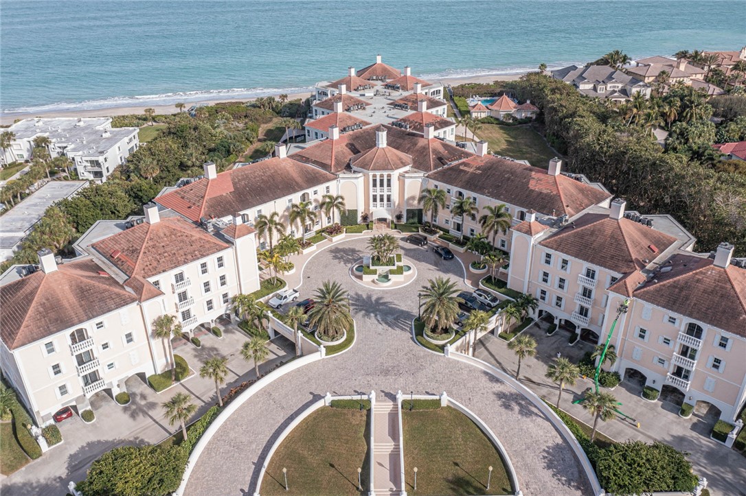 an aerial view of a house with garden space ocean view