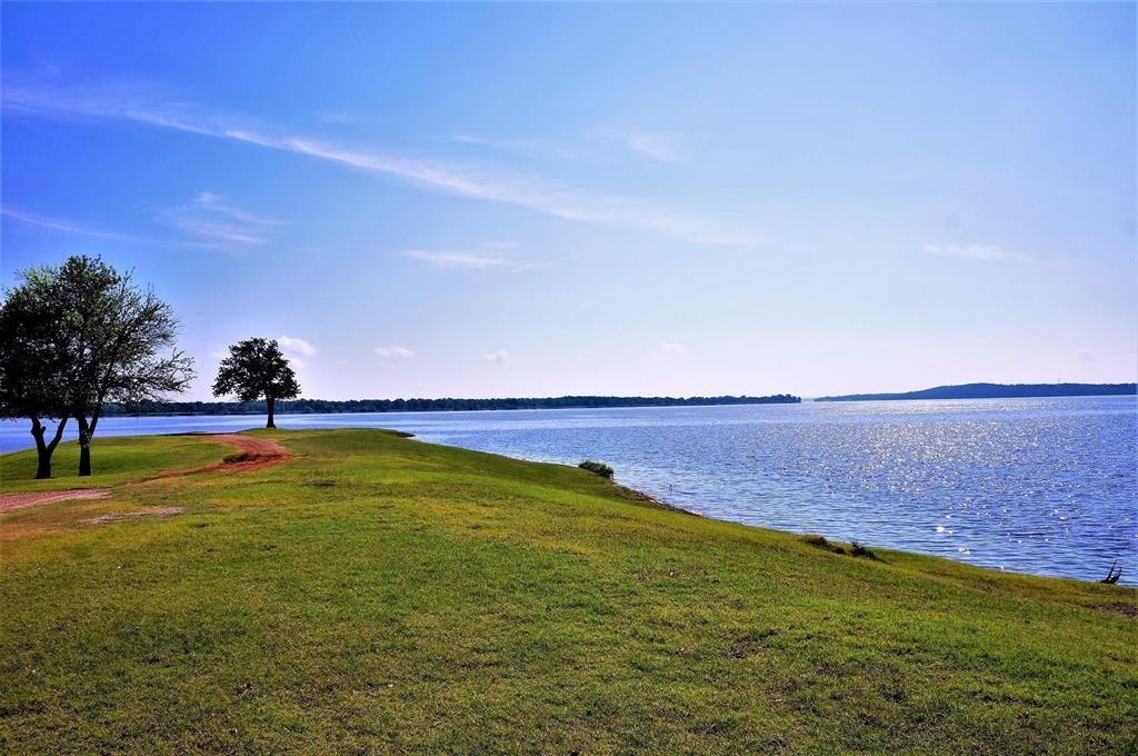 a view of a lake with houses in the back