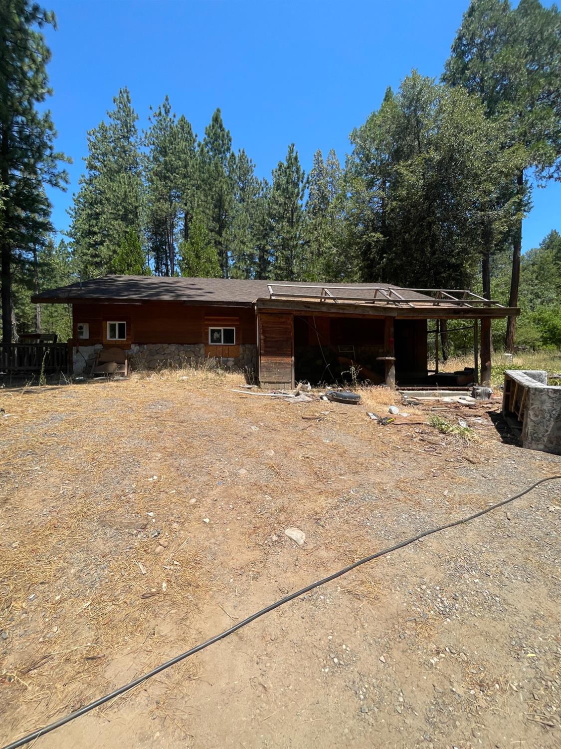 a view of roof deck with chairs and wooden fence