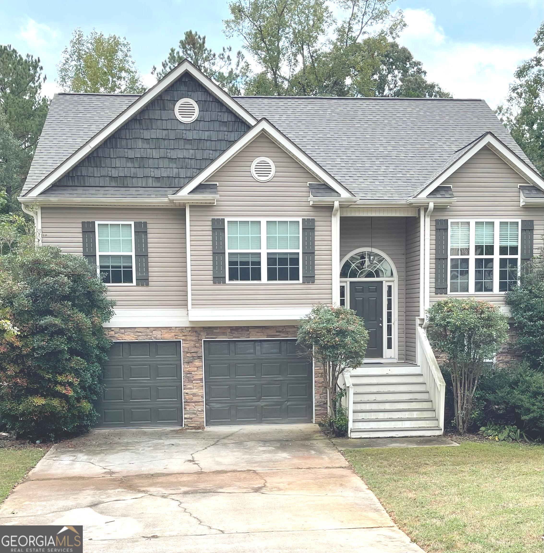 a front view of a house with garden