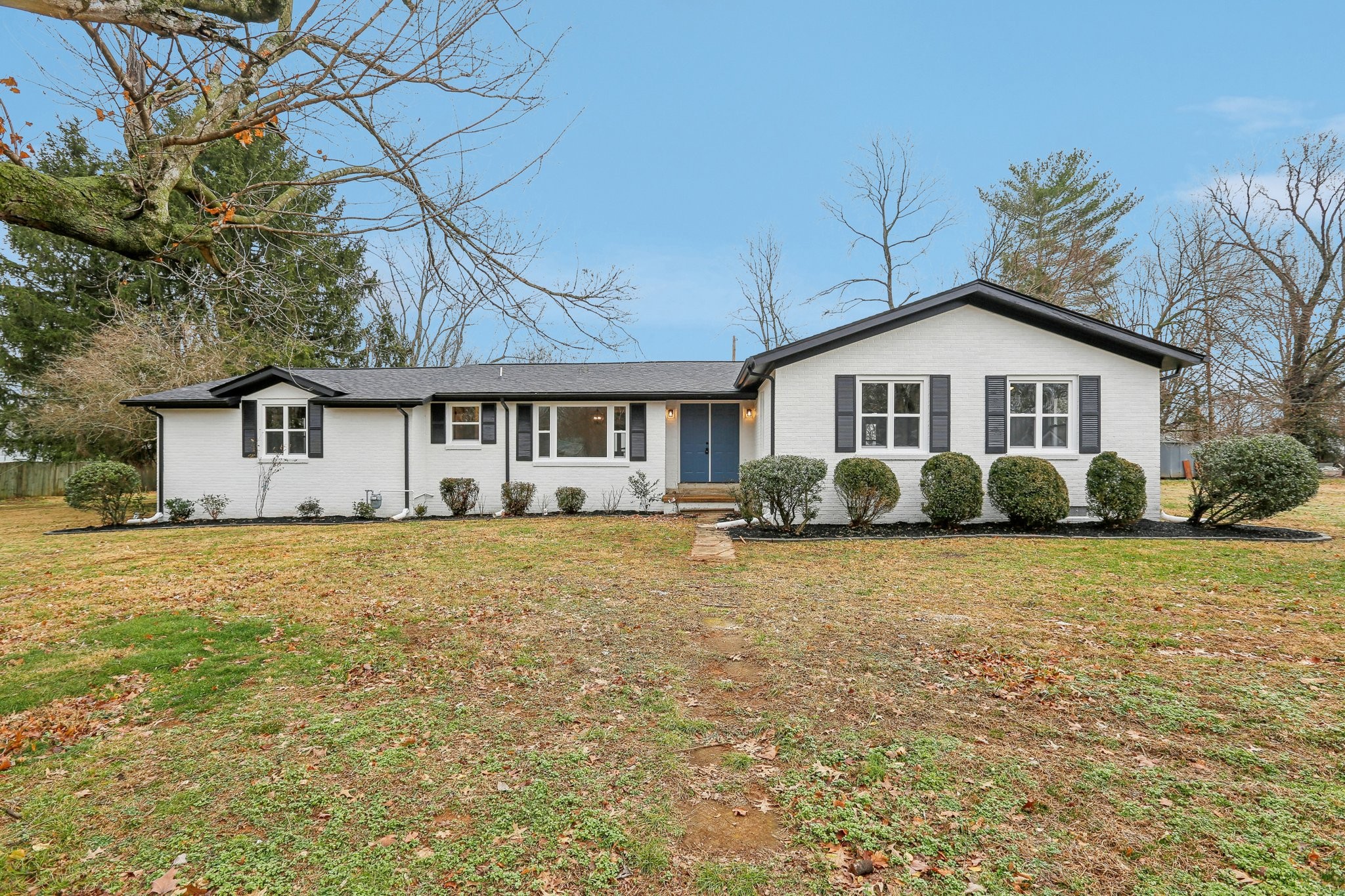 a front view of a house with a garden