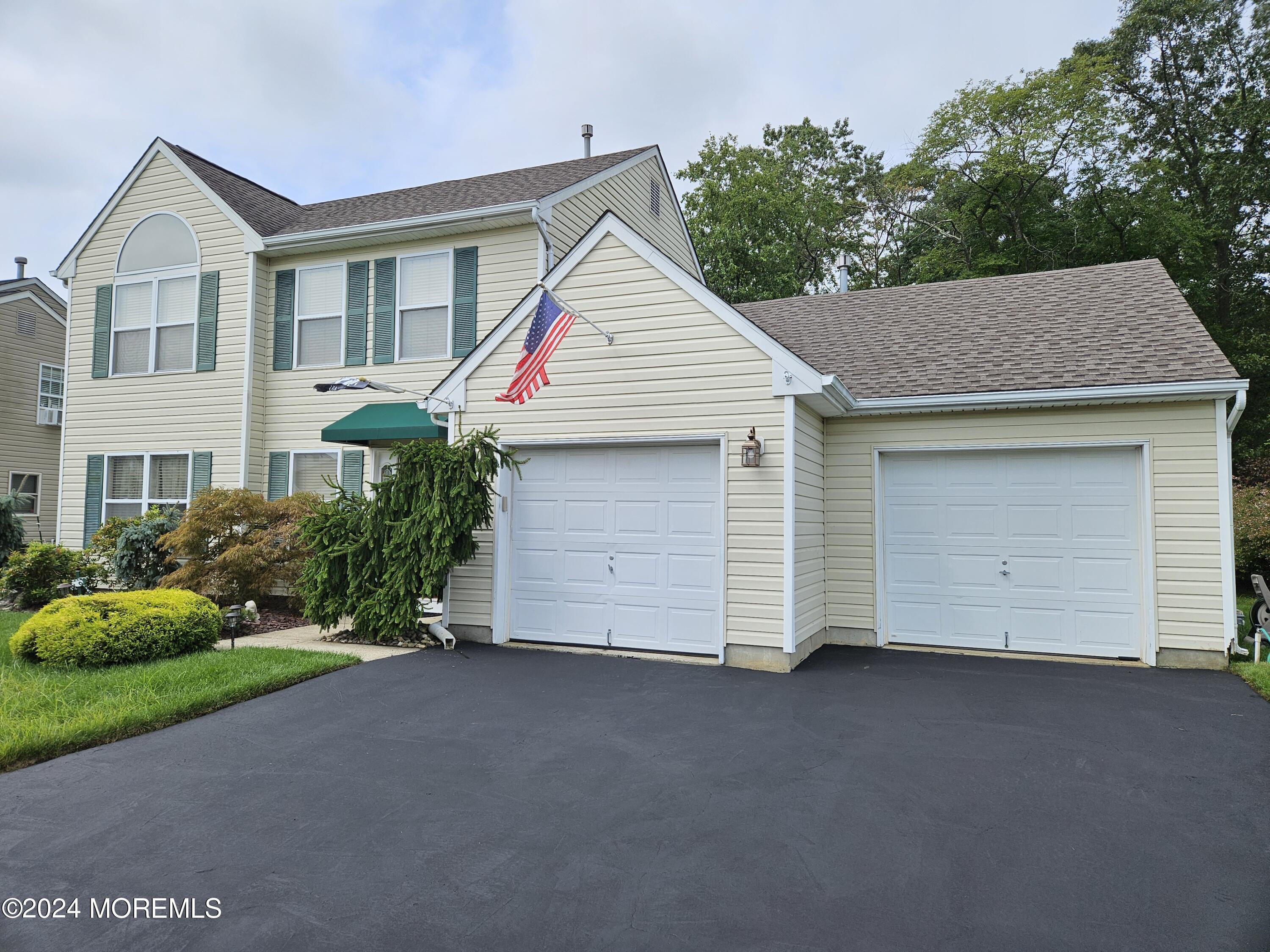 a view of a house with a yard and garage