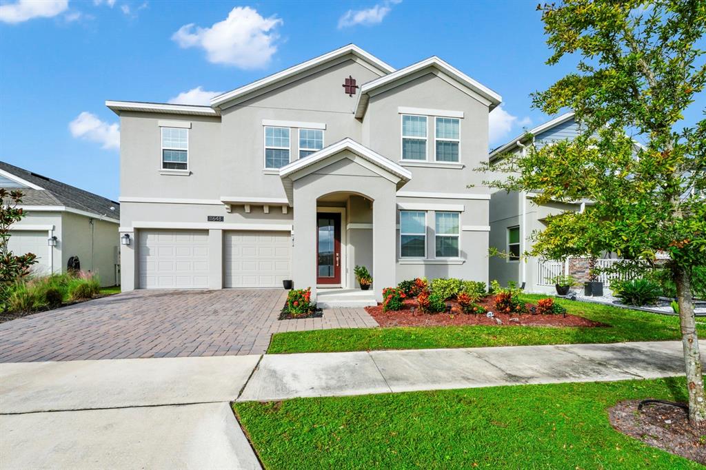 a front view of a house with a yard and garage