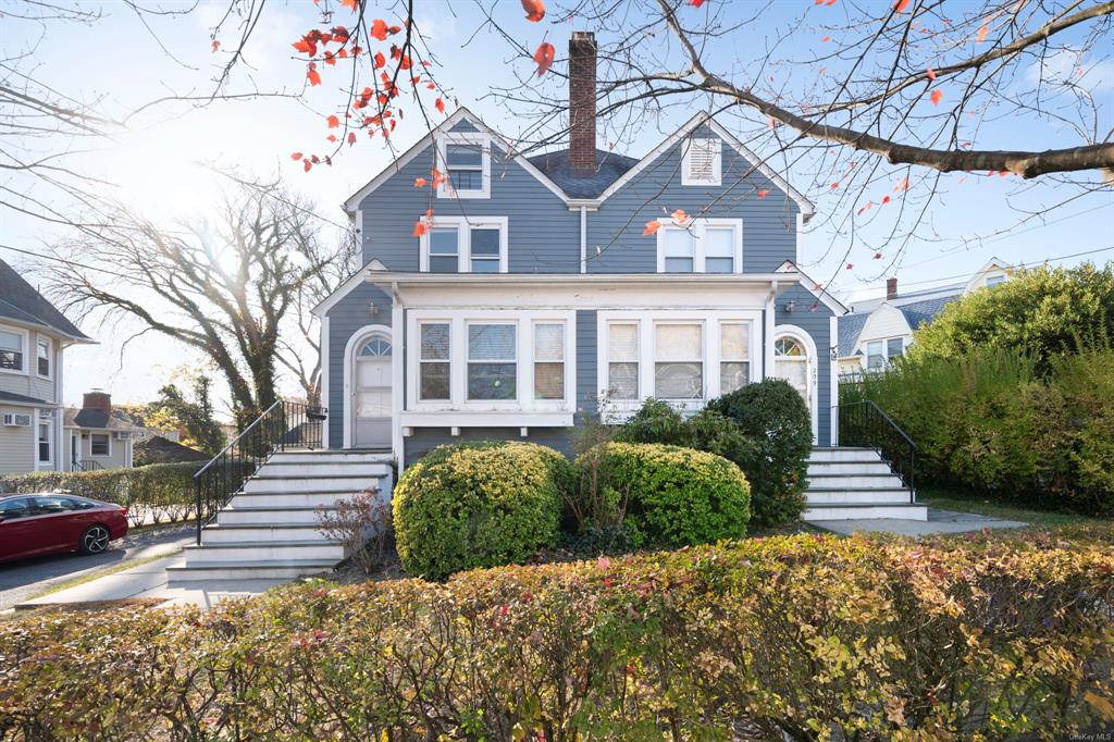 a front view of a house with a garden