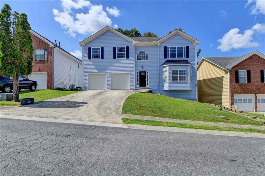 a front view of a house with a yard and garage