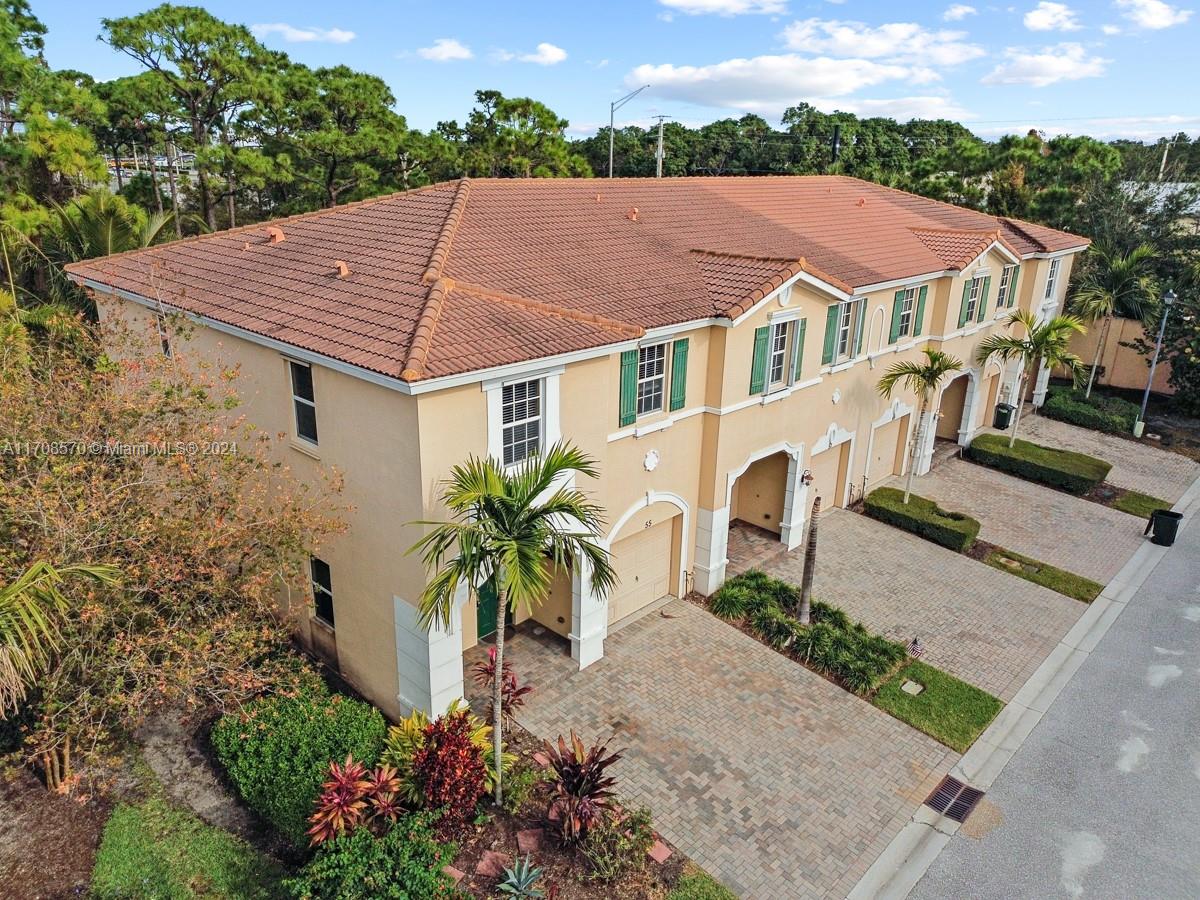 a aerial view of a house with a yard and potted plants