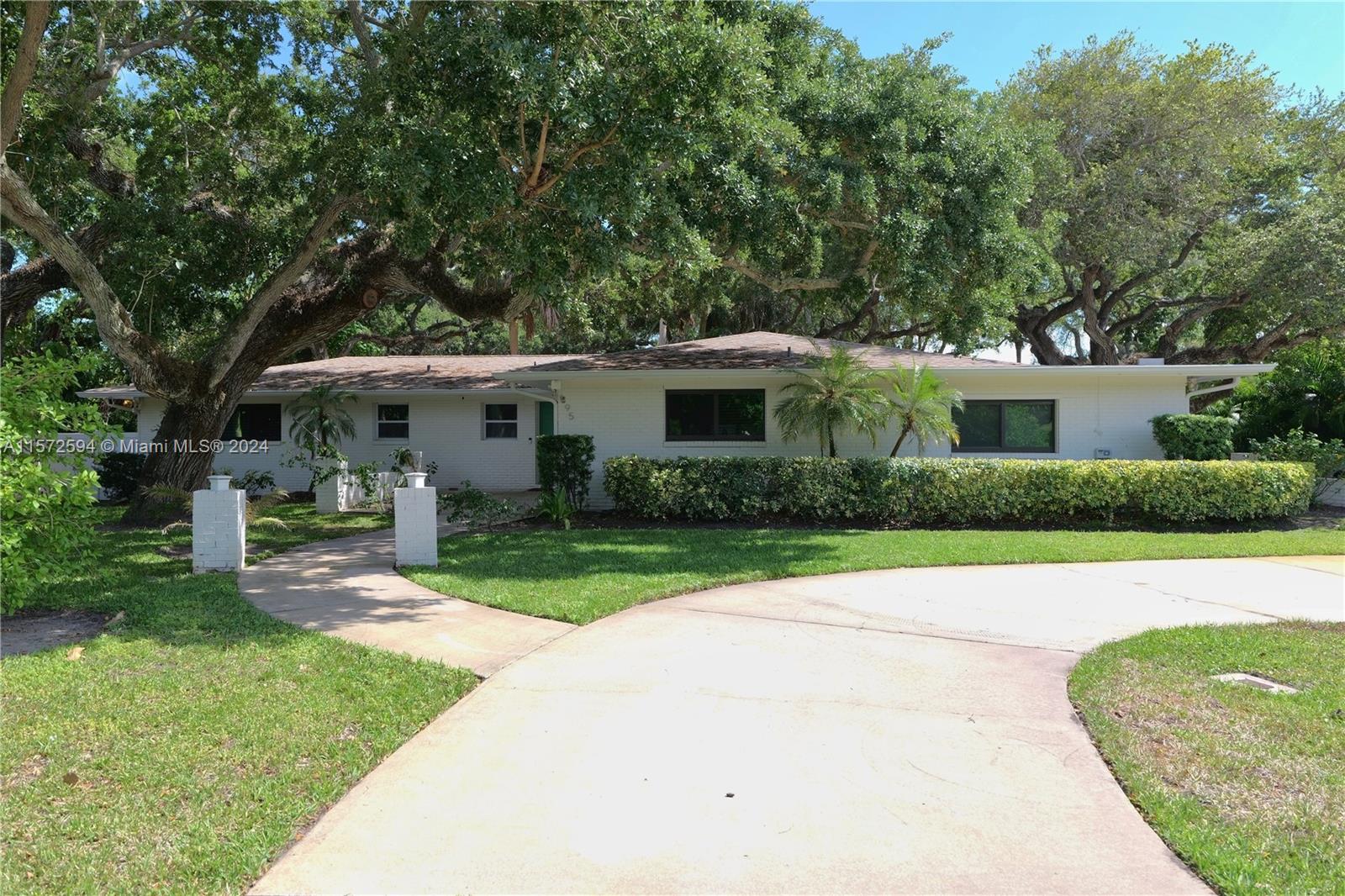 a front view of a house with a yard and porch