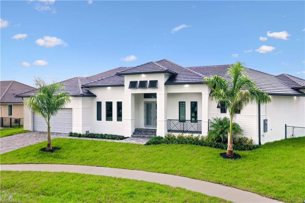 View of front of home with a front lawn and a garage