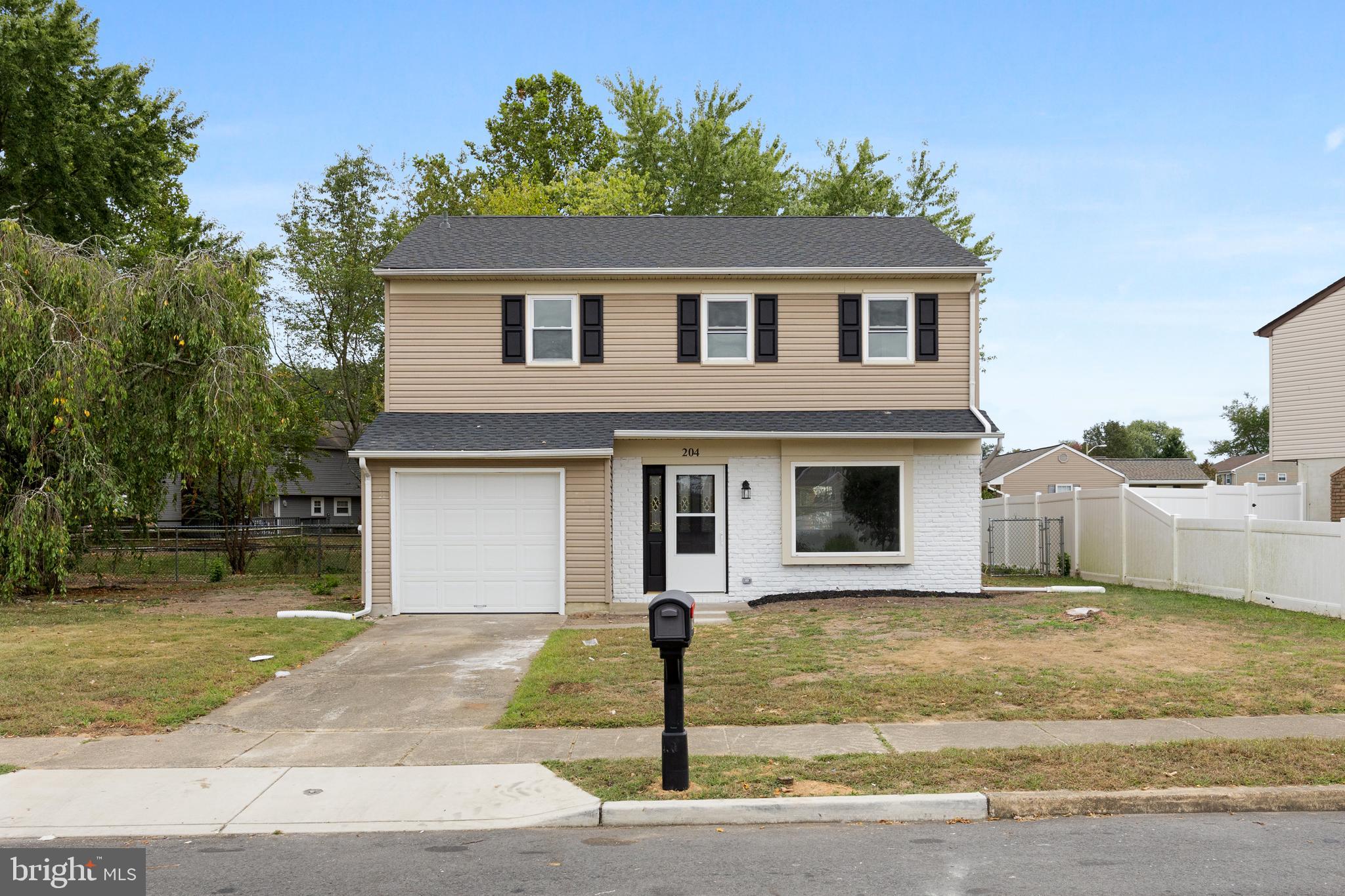 a front view of a house with garage