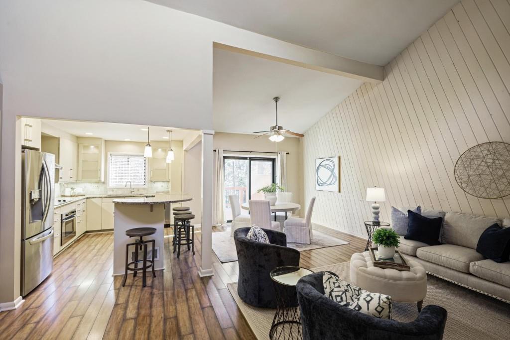 a living room with furniture dining table and wooden floor