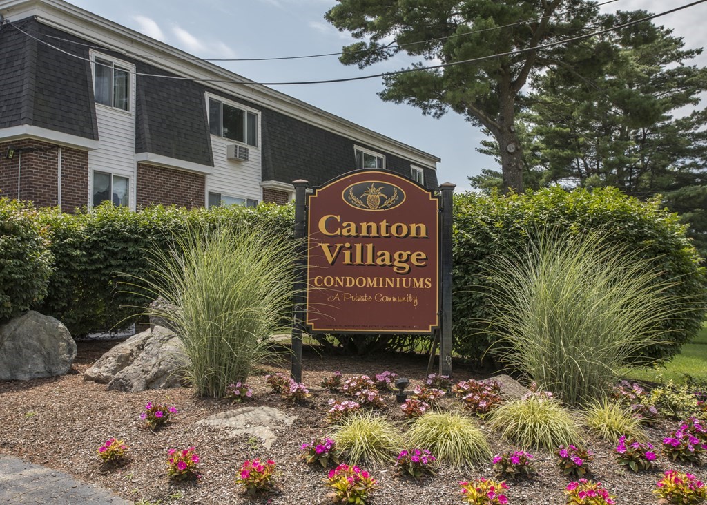 a sign broad in front of flowers