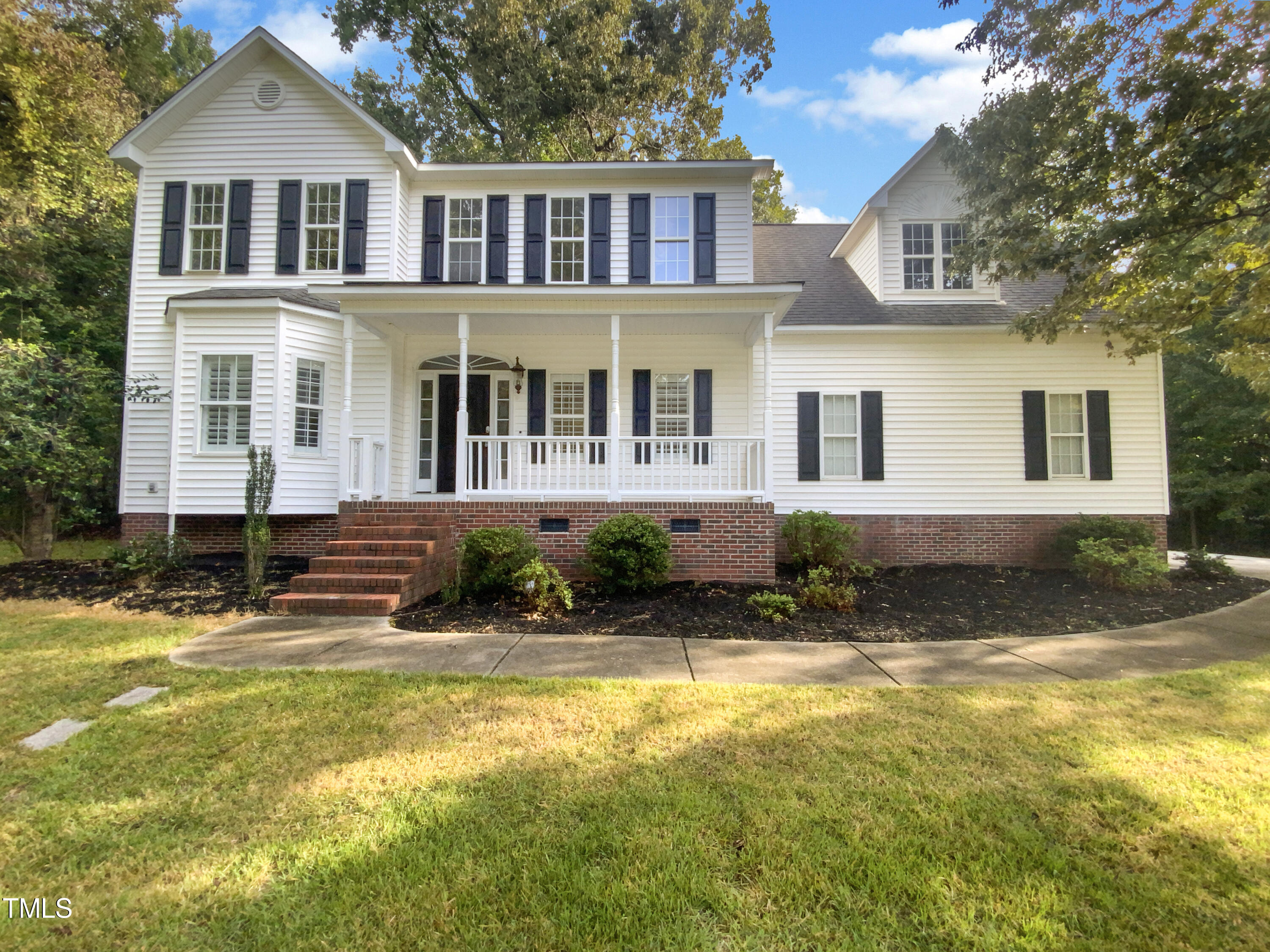 a front view of a house with a yard outdoor seating and garage