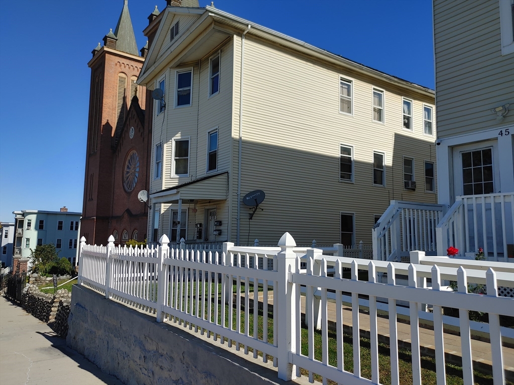 a view of a house with wooden fence