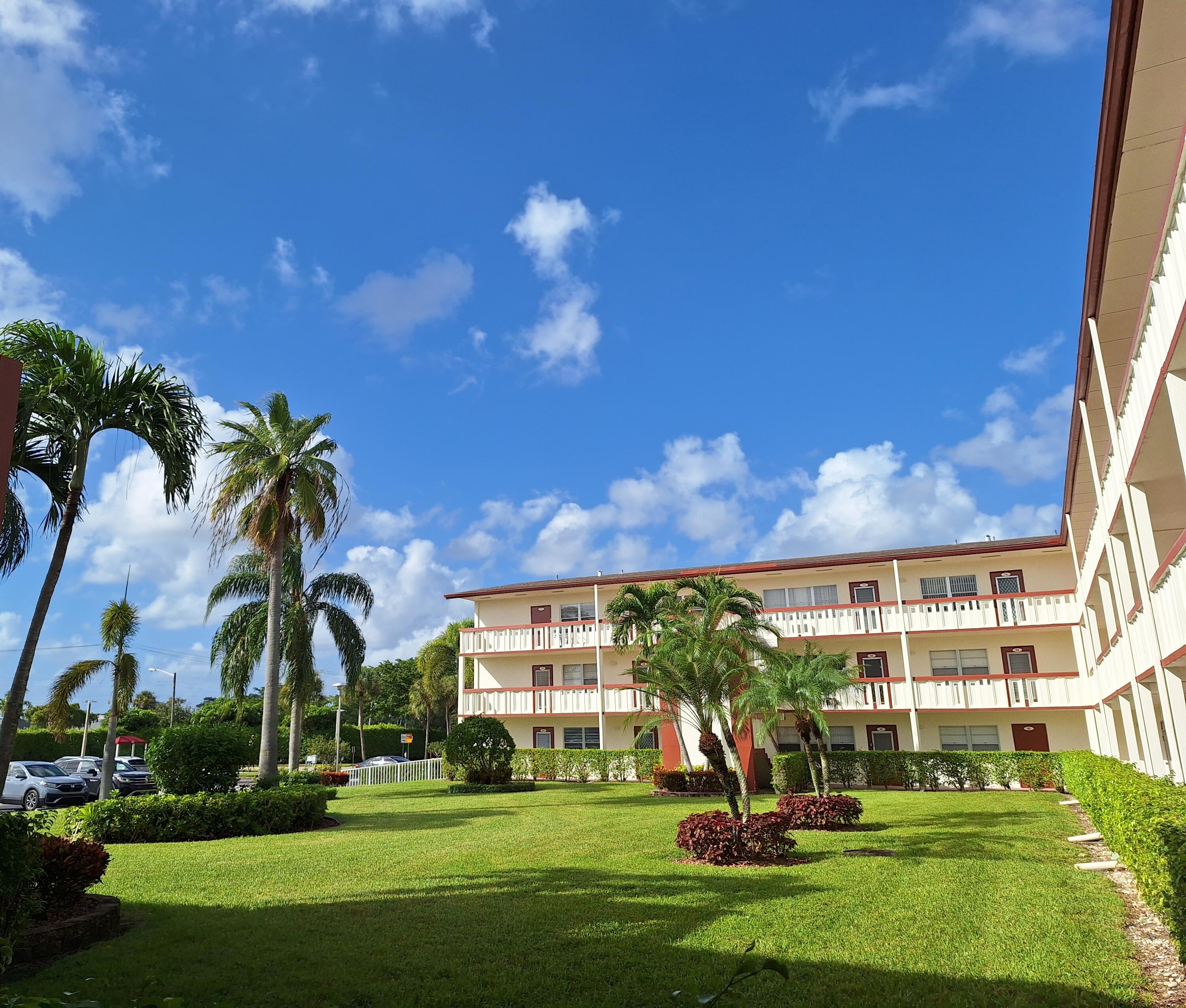 a front view of a building with a big yard