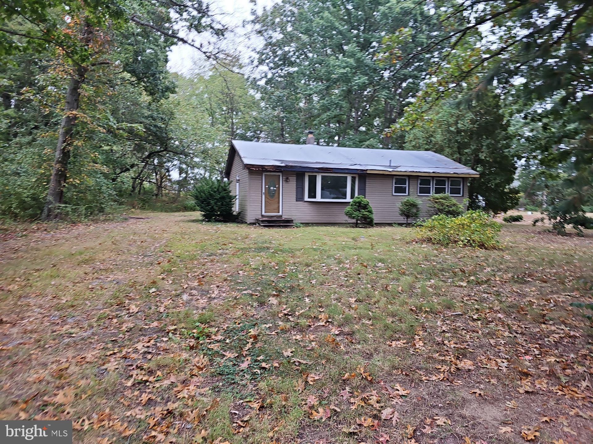 a house that has a tree in front of it