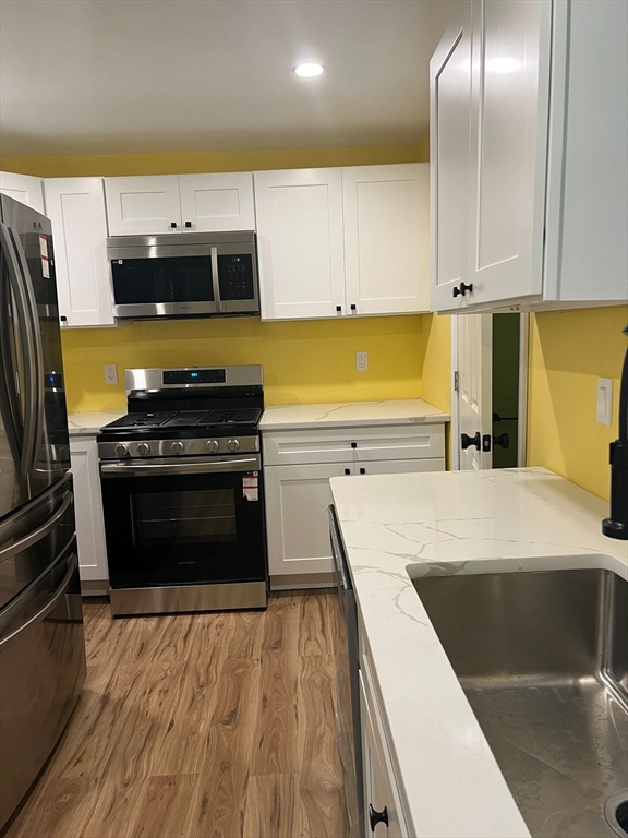 a kitchen with a stove and a refrigerator