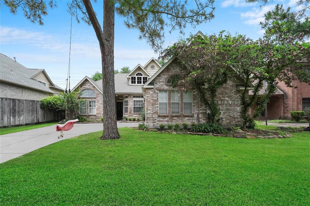 a view of a house with a yard and tree s