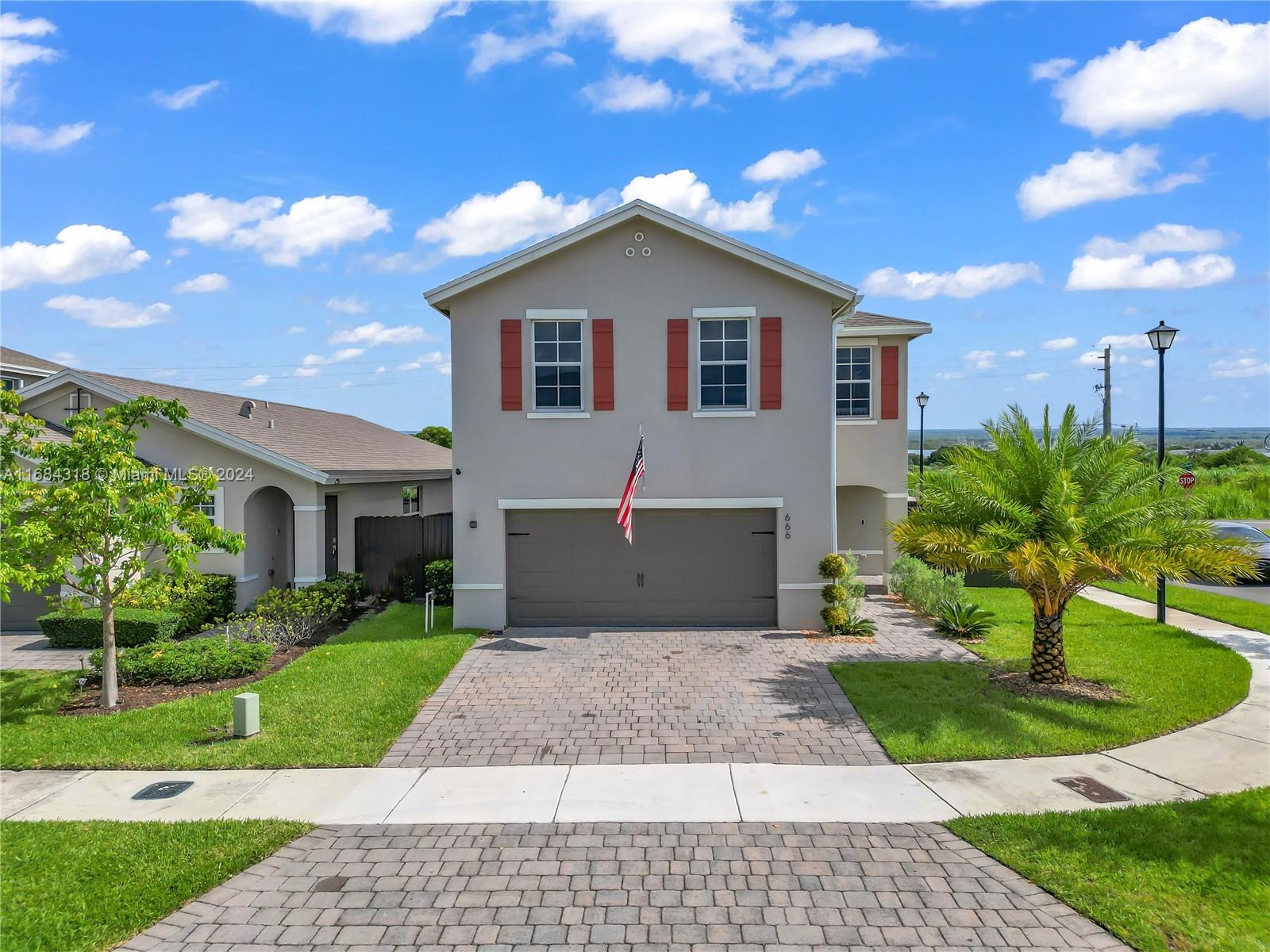 a front view of house with yard and green space