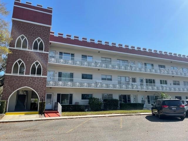 a view of building with cars parked