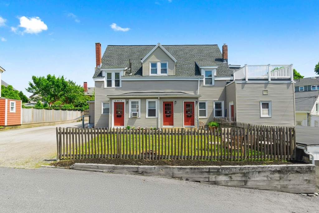 a view of a house with a fence