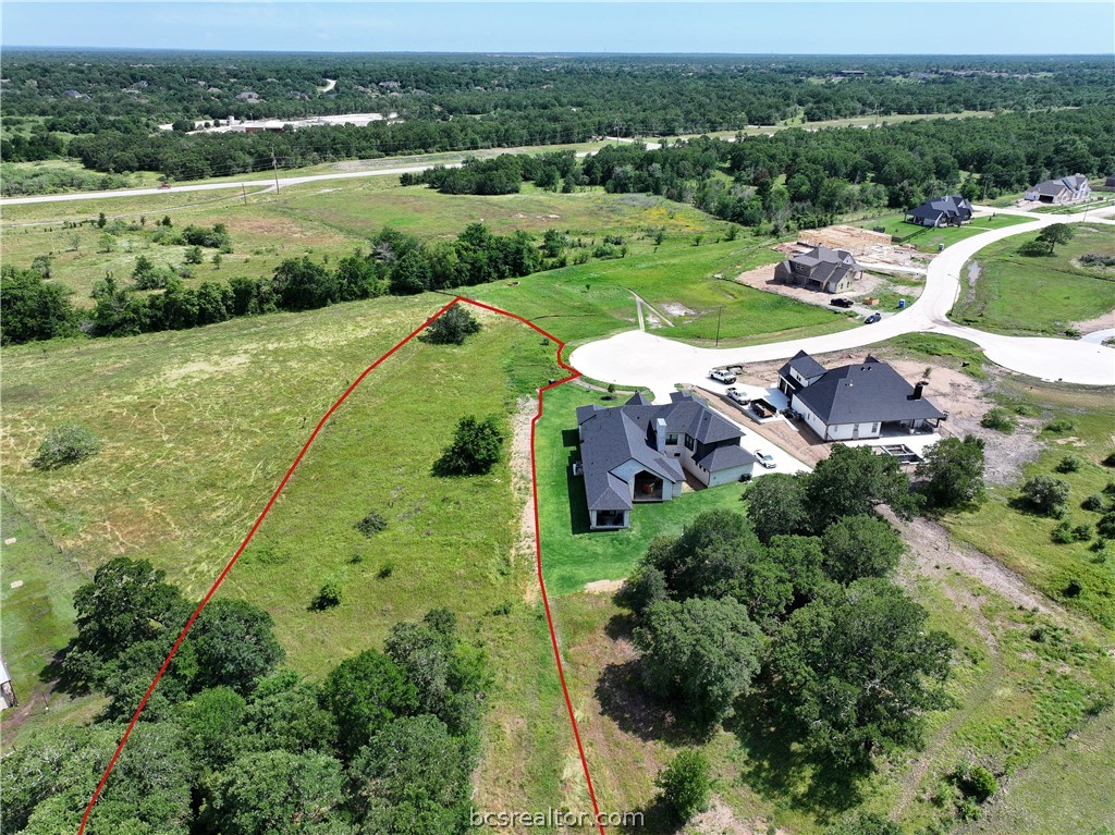 an aerial view of a houses with a yard