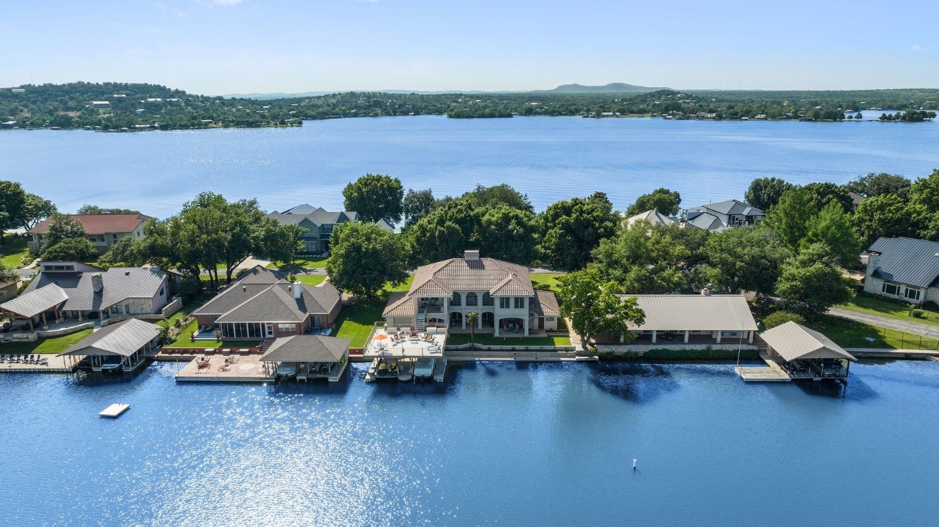 a car parked in front of a lake with houses