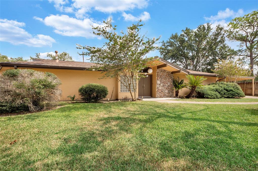 "From an alternative side view, the home’s welcoming entrance and elegant front design are on full display. The angle showcases the seamless blend of architectural details, framed by a well-manicured landscape, and highlights the inviting entryway, offering a charming perspective of the home's exterior."