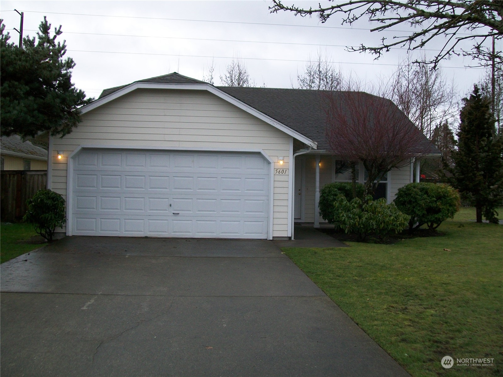 a front view of house with yard and trees