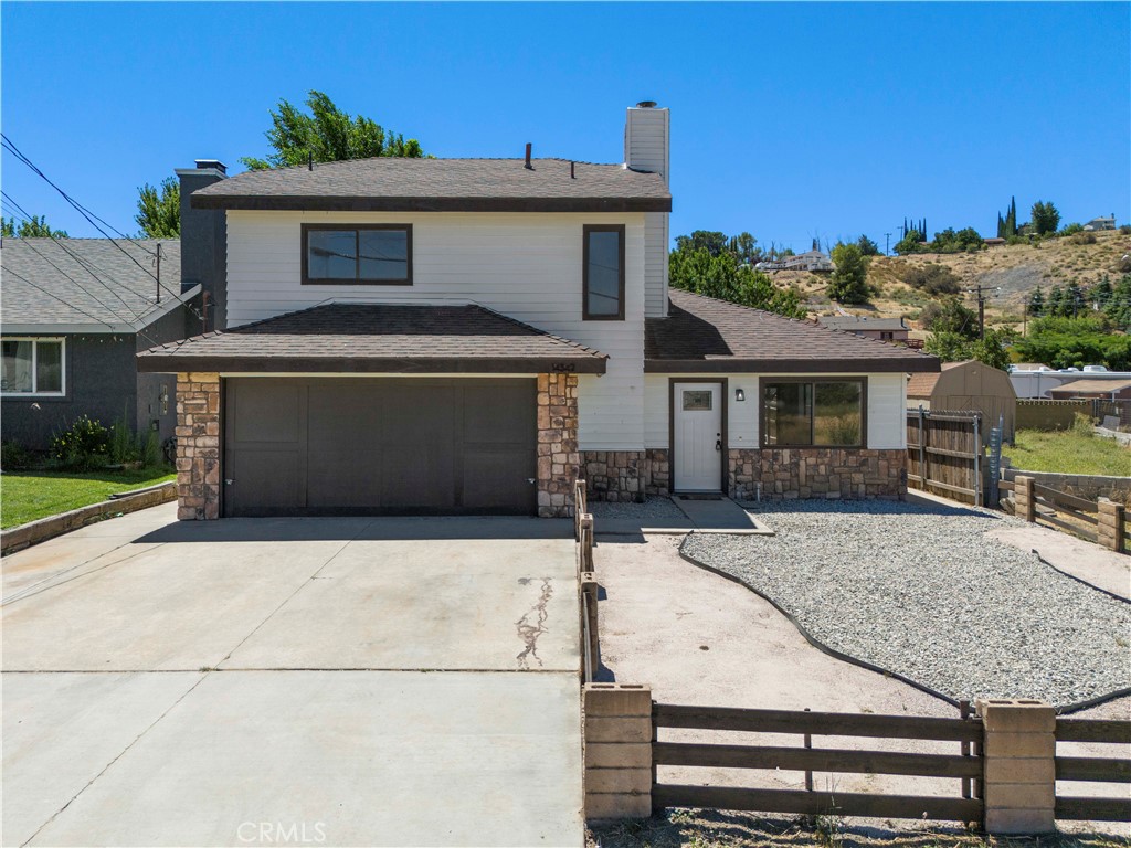 a front view of a house with garage