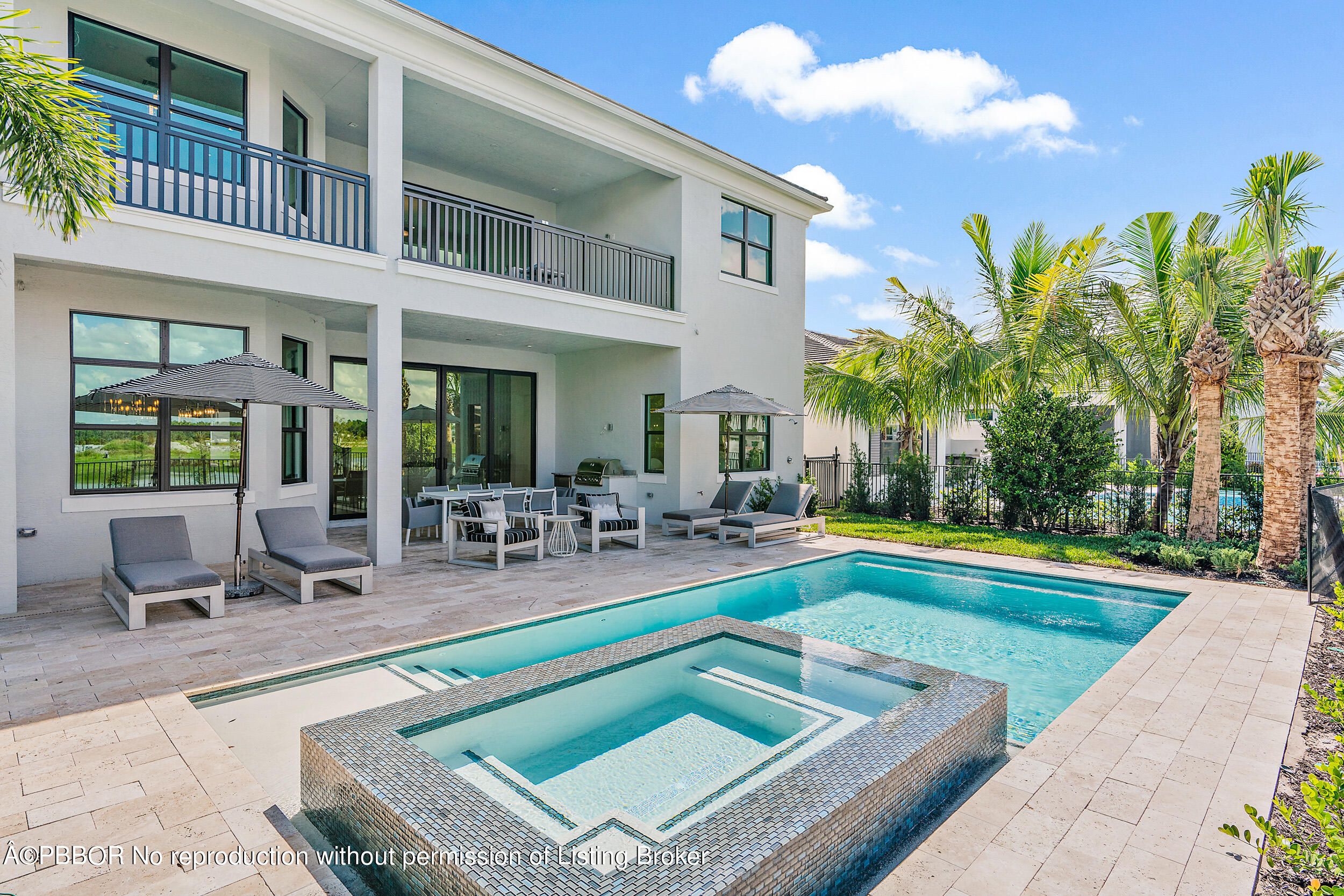 a view of a house with swimming pool and sitting area