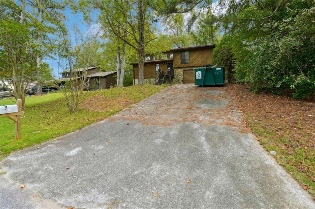 a view of a house with backyard and trees