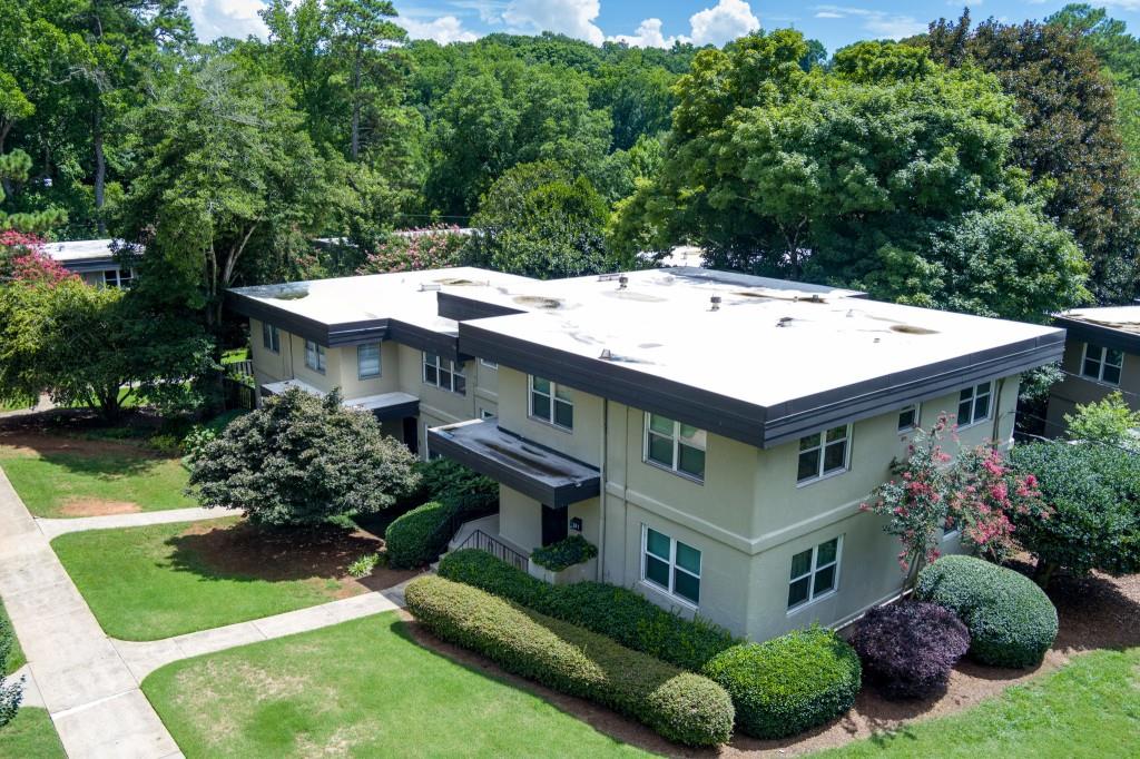 an aerial view of a house with yard and patio