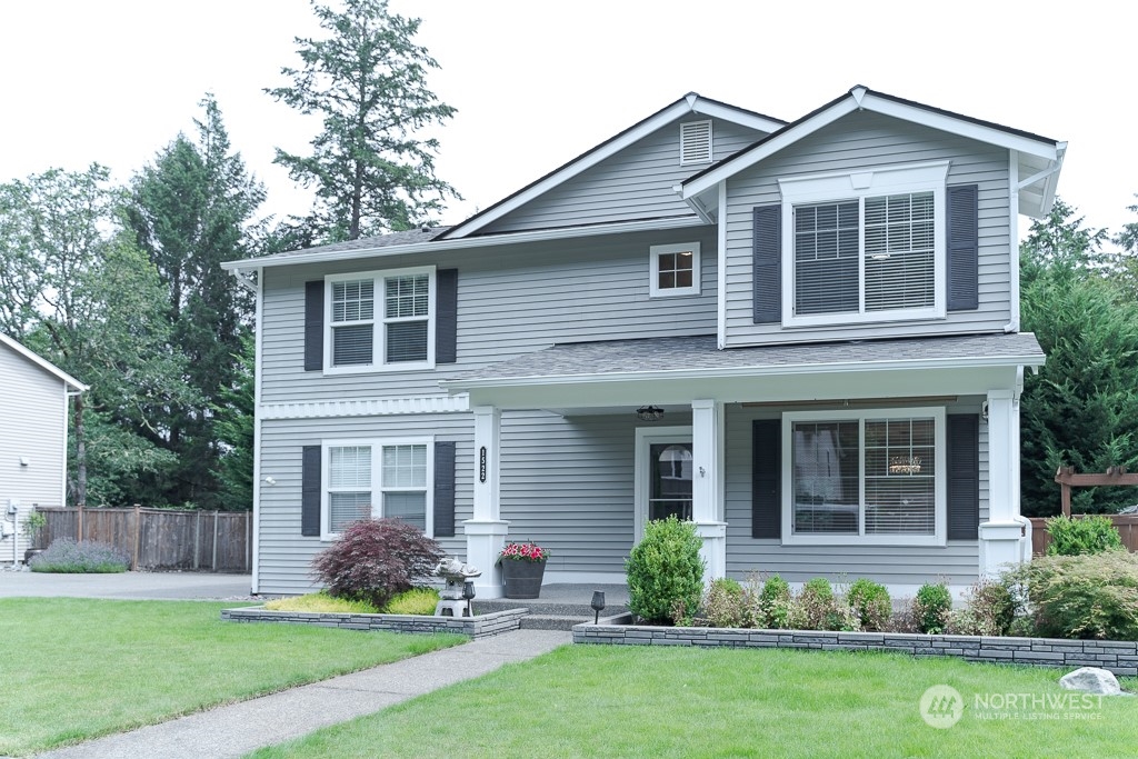 a front view of a house with a yard and porch