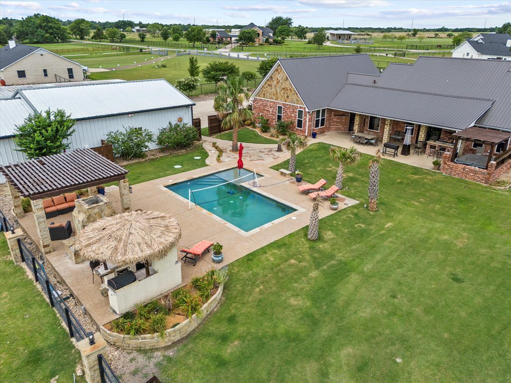 an aerial view of a house with outdoor space and a lake view