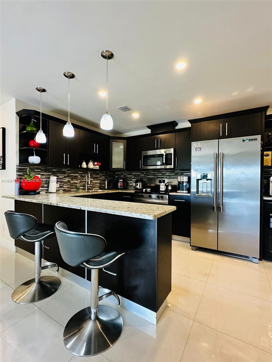 a kitchen with counter space cabinets and appliances