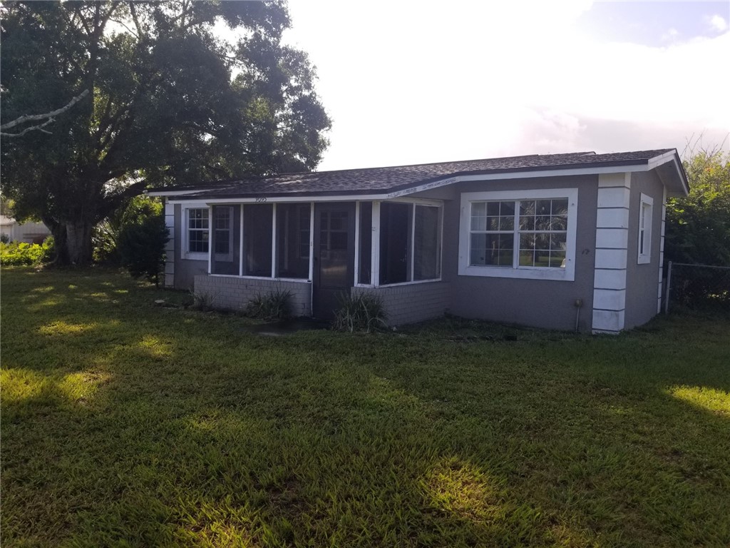 a view of house with backyard space and garden